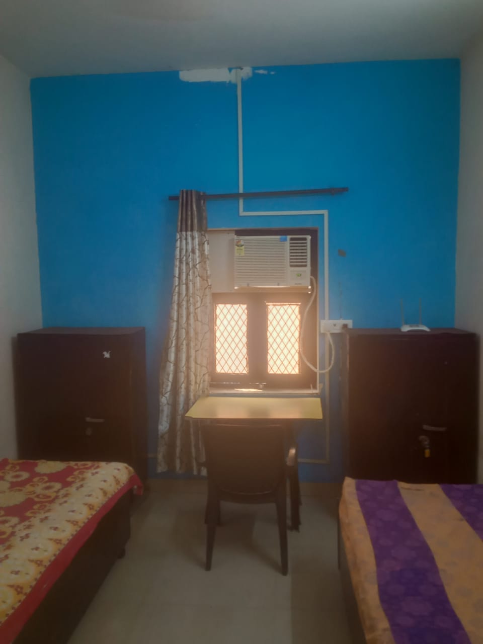 Spacious bedroom at Mittal PG with study table